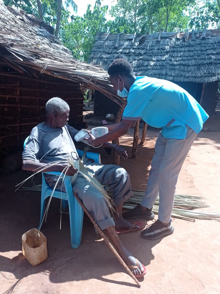 Student practises blood pressure measurement in a community outreach. Photo: &copy; Rebekah Makau