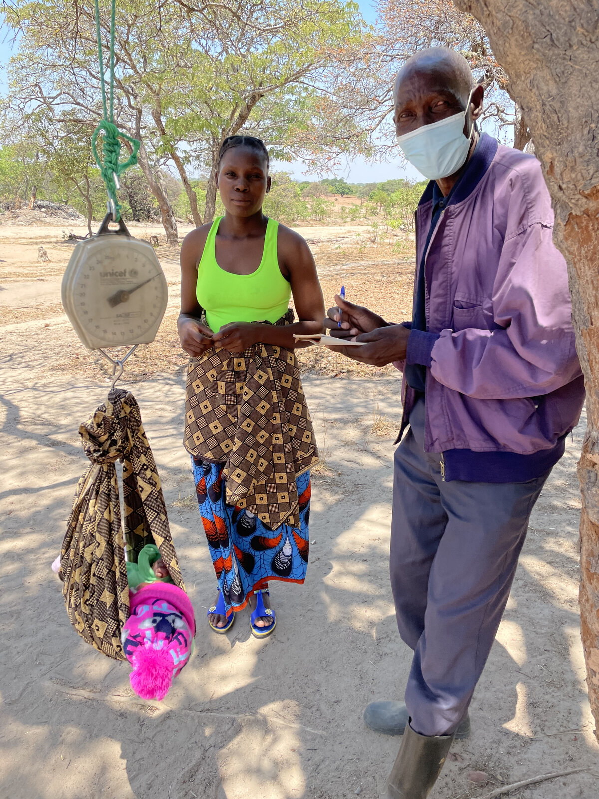 Peter weighing babies at outreach. Photo: &copy; OCA<br>