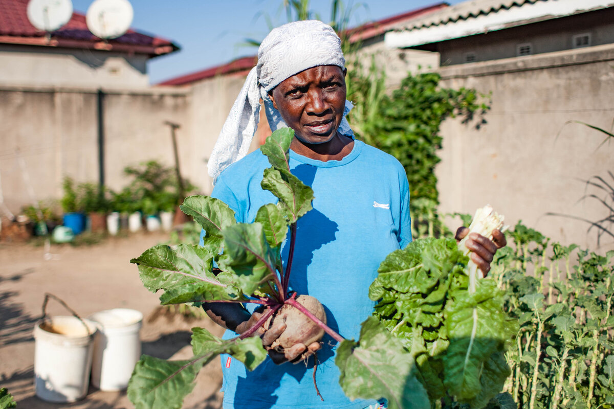 Joline watering her garden to provide for her family. Photo: &copy; Ruedi L&uuml;thy Foundation/ Mkhululi Thobela<br>