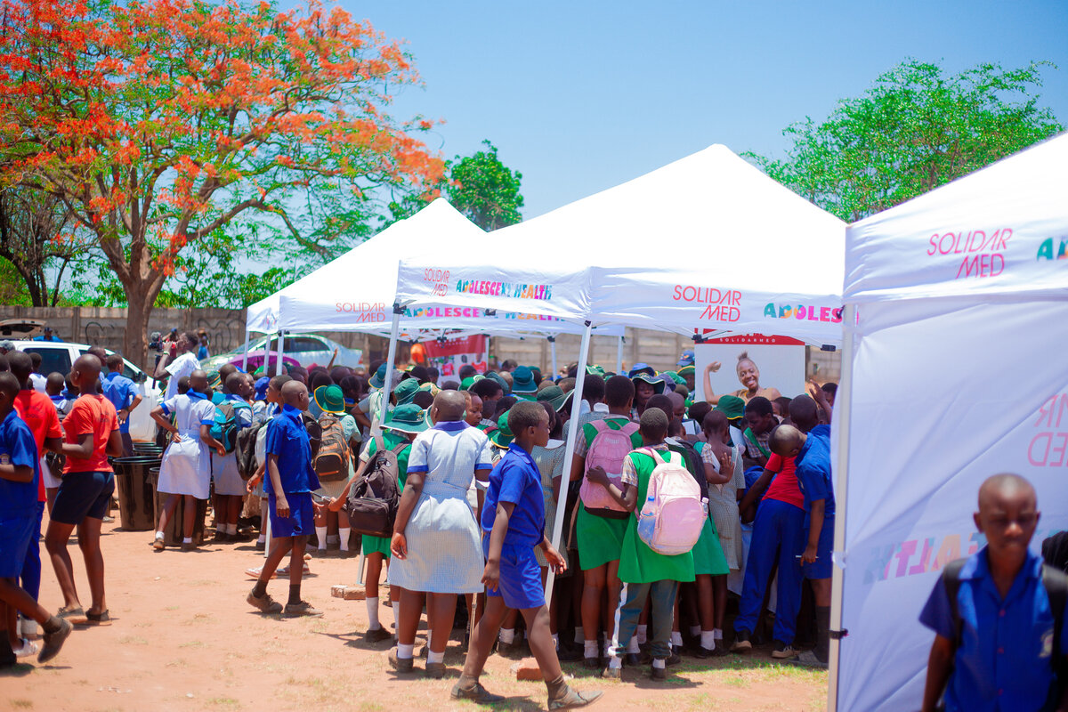 Adolescents crowded around the tents to be part of the discussions about their health and wellbeing. Photo: &copy; Winston Musorowembudzi