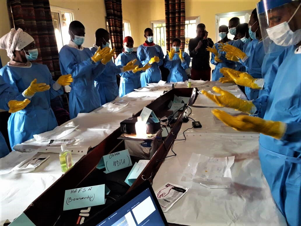 Practice session during an infection prevention training for health workers in Conakry. Photo: &copy; Norohaingo Andrianaivo